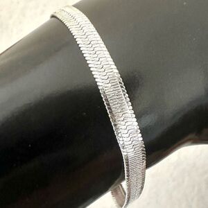 Silver tone herringbone chain bracelet